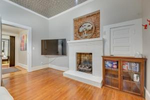 a living room with a fireplace and a tv at Cozy and Modern Norcross Hideaway with Covered Porches in Norcross