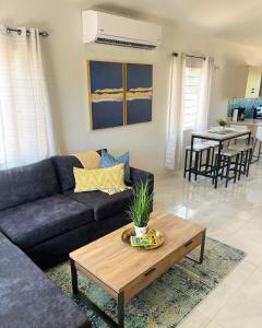 a living room with a couch and a table at Yaad Oasis in Discovery Bay
