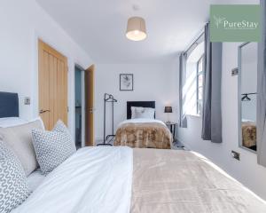 a white bedroom with a large bed in it at Stunning Central House By PureStay Short Lets & Serviced Accommodation Birmingham in Birmingham