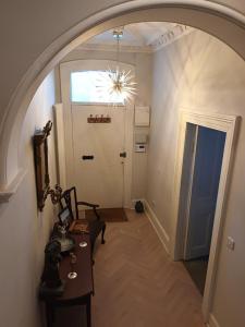 an arched hallway with a table and a door at Eglinton Road - Super King - Ensuite in Bray