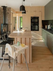 a kitchen with a table and chairs in a kitchen at Siema Siemiany in Siemiany