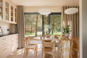 a kitchen with a table and chairs and a large window at Siema Siemiany in Siemiany