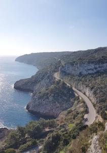 a winding road on a hill next to the ocean at COLOMBO casa per vacanze in corte salentina in Matino