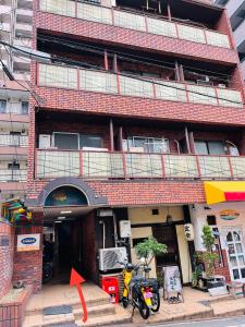 a building with two motorcycles parked in front of it at 心斎橋、道頓堀徒歩10分！難波、黒門市場、徒歩圏内の最高の立地 in Osaka