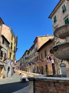 a city street with buildings and flags in a town at acasasiena in Siena