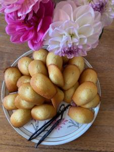 a plate of potatoes and flowers on a table at Flowers By Yasmine Trouville in Trouville-sur-Mer