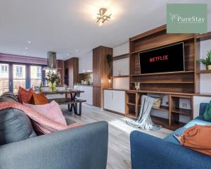 a living room with a couch and a tv at Stunning Five Bedroom House By PureStay Short Lets & Serviced Accommodation Manchester With Free Parking in Manchester