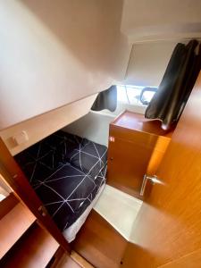 an overhead view of a bunk bed and a chair at Une nuit insolite sur un bateau - BOAT PARADISE LA ROCHELLE in La Rochelle