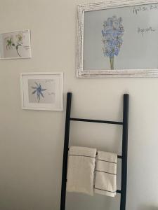 a towel rack in a bathroom with two towels at Flowers By Yasmine Trouville in Trouville-sur-Mer