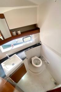 a small bathroom with a toilet and a sink at Une nuit insolite sur un bateau - Linge & ménage inclus in La Rochelle