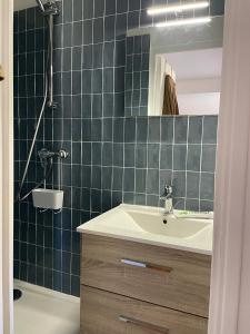 a bathroom with a sink and a mirror at Colourful loft in Marseille in Marseille