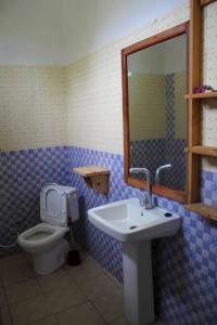 a bathroom with a sink and a toilet at Pamoja Beach Stays Hotel in Jambiani in Jambiani