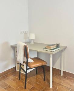 a desk with a chair with a lamp and a book at Casa Amaranto: tranquility and charming place in San Andres y Sauces