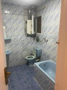a bathroom with a toilet and a bath tub at sea zone in Alexandria