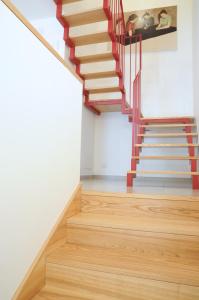 a staircase in a house with wooden floors at Ypsilhome in Castelbuono