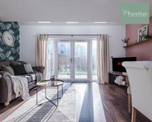 a living room with a couch and a table at Amazing Four Bed House At PureStay Short Lets & Serviced Accommodation Manchester Near Etihad With Parking in Manchester