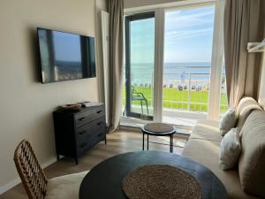 a living room with a view of the ocean at Kaiserhof 311 mit Meerblick - Reinke in Norderney