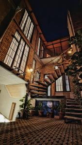 a large building with windows and a staircase in it at City Center Van Gogh Suite in Tbilisi City