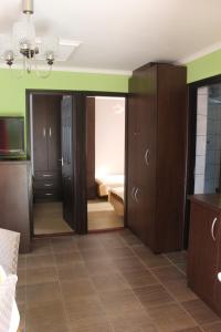 a room with wooden cabinets and a bedroom with a bed at Mesteri Apartman in Mesteri