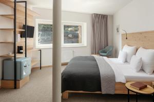 Postel nebo postele na pokoji v ubytování Ski & Spa hotel BELLEVUE