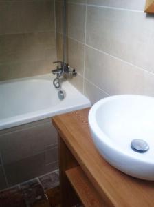 a bathroom with a white sink and a bath tub at Le Foulon - Moulin de Charme - 1 heure 30 de Paris in Saint-Hilaire-les-Andrésis +135 photos