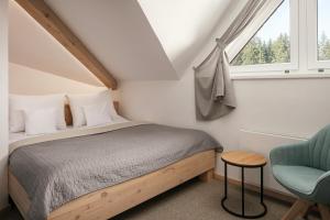 Postel nebo postele na pokoji v ubytování Ski & Spa hotel BELLEVUE