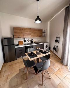 a kitchen with a table and chairs in a room at Sicily O’Clock House in Lentini