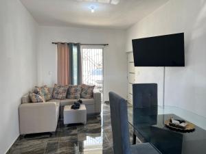a living room with a couch and a table at City suite Apartment 1 Cabrera in Cabrera