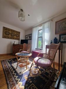 a living room with two chairs and a table and a window at B&B Le Moulin de Fernelmont in Forville