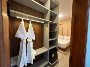 a bathroom with towels hanging on a closet at Pousada Villas - Bonito in Bonito