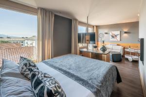 Posteľ alebo postele v izbe v ubytovaní hirschen dornbirn - das boutiquestyle hotel - skyrelax & wellness im rooftop