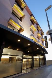 a building with a sign on the side of it at Hotel Ciutat de Tarrega in Tárrega