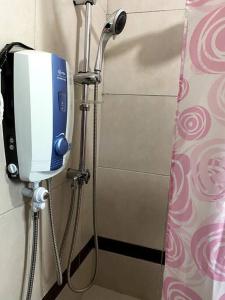a shower stall with a blue and white soap dispenser at Pacho- All en-suite 2br in Kisumu