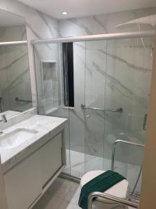 y baño con ducha acristalada y lavamanos. en Apartamento Princesa Isabel, en Salvador