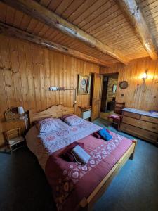 a bedroom with a large bed in a wooden room at Belle Vue Des Praz in Chamonix-Mont-Blanc