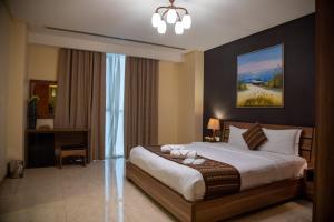 a bedroom with a large bed in a room at Juffair Trends Luxury Apartment in Juffair +42 photos
