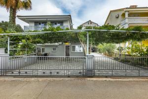 a metal gate in front of a house at Apartment Pivas Nr 3 in Malinska