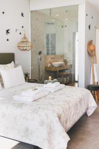 1 dormitorio con 1 cama grande y toallas. en Casa L-N-Noa Boutique room whit private pool, en Lagos