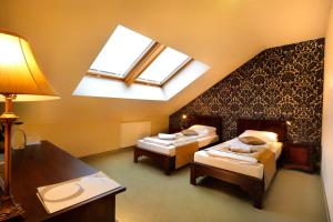 a attic room with two beds and a skylight at Residence9 in Krakow