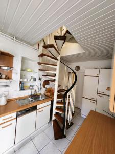a kitchen with a spiral staircase in the ceiling at Haus für Monteure in Baden-Baden in Baden-Baden