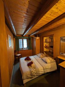 a bedroom with a large bed in a wooden room at Belle Vue Des Praz in Chamonix-Mont-Blanc
