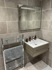 a bathroom with a sink and a mirror at Top Floor Flat - Glasgow West End - Partick in Glasgow