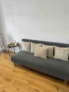 a couch with pillows on it in a living room at Top Floor Flat - Glasgow West End - Partick in Glasgow