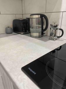 a kitchen counter with a appliance on a counter top at Top Floor Flat - Glasgow West End - Partick in Glasgow