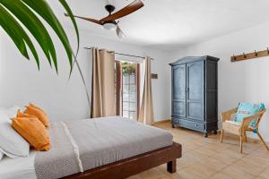a bedroom with a bed and a blue cabinet at Villa Munay in Puerto del Carmen