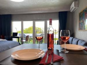 a table with two glasses of wine on it at Danube view Artapartment with balcony in Budapest