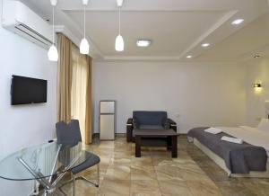 a hotel room with a bed and a chair at Apartaments on Komitas 20 in Yerevan