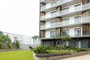 an apartment building with a lawn in front of it at Airport Residential Suite in Accra