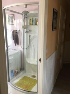 a shower with a glass door in a bathroom at Chez Armelle in Hesdin