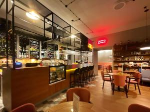 a restaurant with a bar with tables and chairs at Residence 9 in Krakow